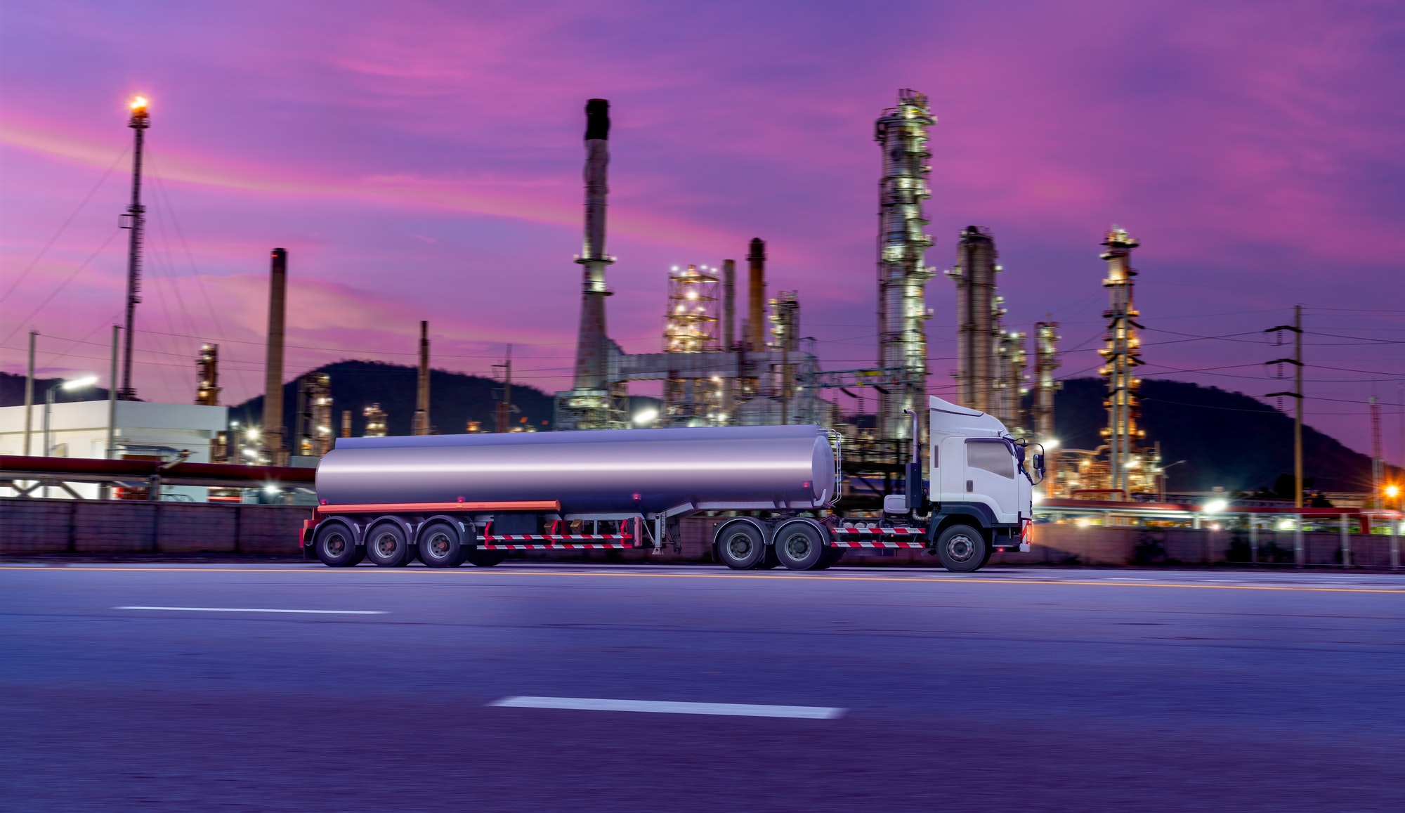 Gasoline tanker with fuel tanker truck shipping speed on high way road to delivery logistic business